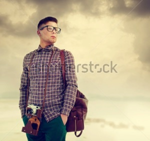 stock-photo-young-handsome-man-with-a-camera-dressed-in-the-style-of-hipster-129620081